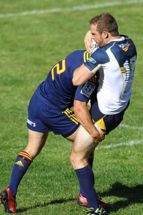 Pat McCabe cops a heavy tackle against the Highlanders.