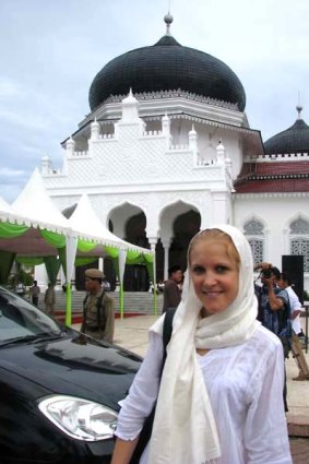 The writer loosely dressed according to shariah law in front of Baturrachman Mosque, Banda Aceh's main mosque, on Prophet Muhammad's birthday.