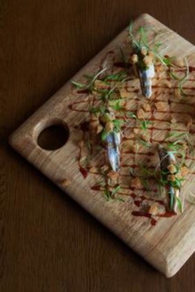 Anchovy fillets on bamboo shoots.