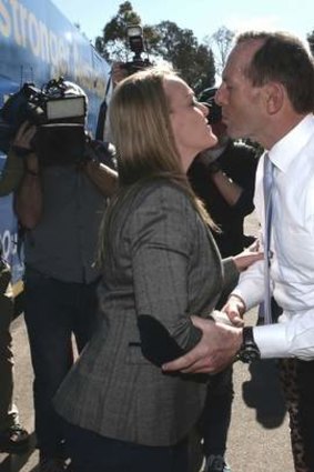 Pucker up: Repeat offender Tony Abbott with candidate Fiona Scott.