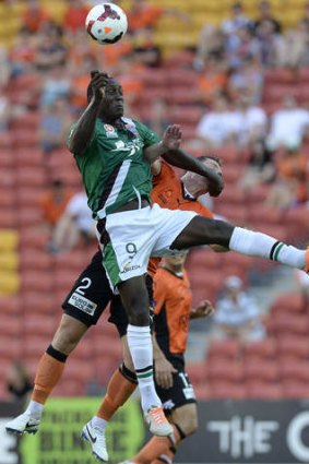 Rising to the challenge: Newcastle's Emile Heskey outleaps Matthew Smith of the Roar.