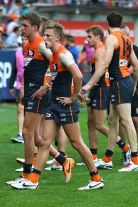 Giant letdown: GWS players trudge off after being thrashed by Richmond last Saturday.