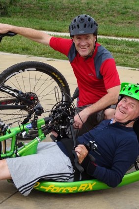 Andrew Kerec and his dad Lud with Lud's hand-driven  cycle.Lud did the first 10km of the journey alongside Andrew.