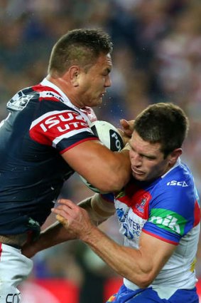 Over the top: Jared Waerea-Hargreaves delivers a knock-out blow to Newcastle's Danny Buderus.
