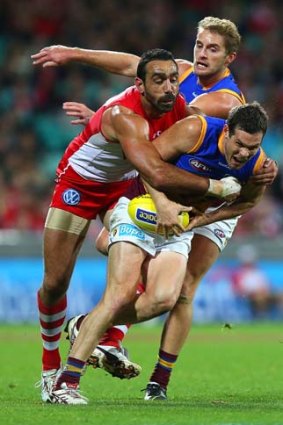 Adam Goodes of the Swans tackles Cheynee Stiller of the Lions during their round 15 match at the Sydney Cricket Ground.