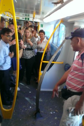 Shocked passengers survey damage to their carriage after a train derailed between Kings Cross and Edgecliff.