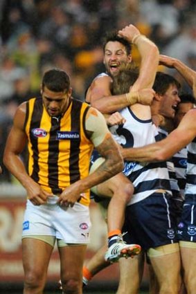 On a roll ... Geelong celebrate after scraping past Hawthorn. The victory extended their winning streak over the Hawks to eight matches.