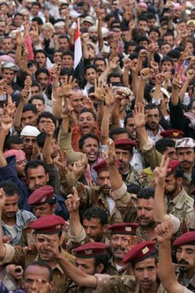 Military personnel shout slogans with anti-government protesters in Yemen.