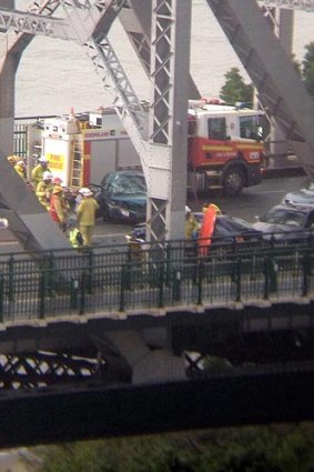 Emergency crews work at the scene of a crash at the Story Bridge.