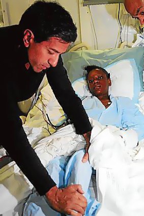 Sanjay Gupta examines an injured Haitian girl in the USS Carl Vinson's hospital.