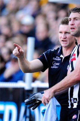 In demand... Travis Cloke receives instructions from Collingwood coach Nathan Buckley.