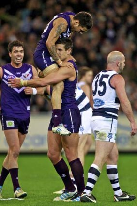 Dockers forward Michael Walters jumps on his captain, Matthew Pavlich, after the skipper's final quarter goal.