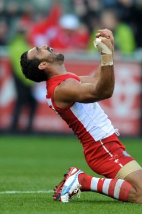 Twice as sweet &#8230; Sydney stalwart Adam Goodes becomes a dual premiership medal winner and drops to his knees after the final siren in yesterday's grand final at the MCG.