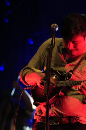 Marcus Mumford on stage with the band.