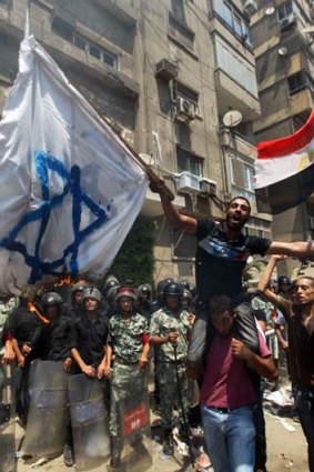 Egyptian demonstrators burn an Israeli flag during a protest outside the Israeli embassy in Cairo yesterday.