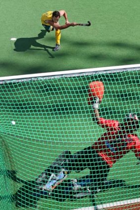 Well struck: Australia's Jamie Dwyer scores from the penalty spot against India.