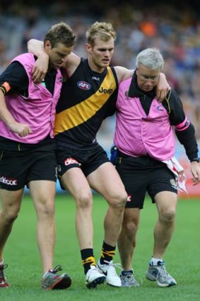 David Astbury is helped off the MCG by trainers on Saturday.