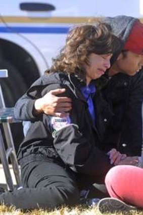 A woman is comforted at the scene of the shootings.