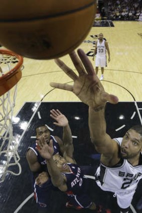 San Antonio veteran Tim Duncan scores over Hawks trio Paul Millsap, Jeff Teague and Al Horford in the Spurs' win over Atlanta, yet another demonstration of the Western Conference's superiority.