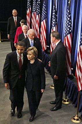President-elect Barack Obama puts an arm around Hillary Clinton as the US national security team leaves a Washington media conference.