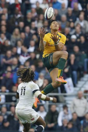 Up and away: Israel Folau uses some of his football skills for the Wallabies.