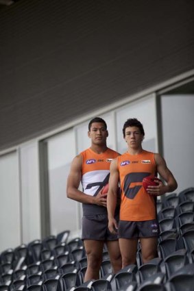 Israel Folau and Dylan Shiel . . . show off the new team jerseys.