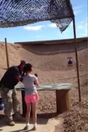 TRAGIC: Shooting instructor Charles Vacca stands next to the 9-year-old girl at the Last Stop shooting range at Bullets and Burgers in White Hills, Arizona.