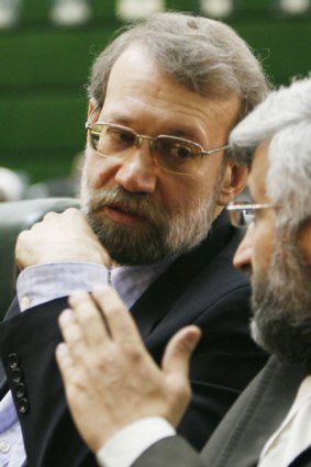 Ali Larijani (left) confers during the opening of parliament.