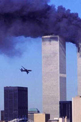 As the north tower of the World Trade Center burns after being struck by hijacked American Airlines Flight 11, hijacked United Airlines Flight 175 nears the south tower.