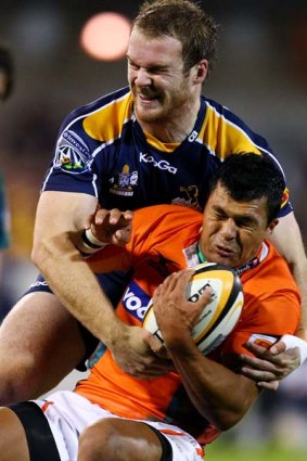 Pat McCabe of the Brumbies tackles Tewis de Bruyn of the Cheetahs.