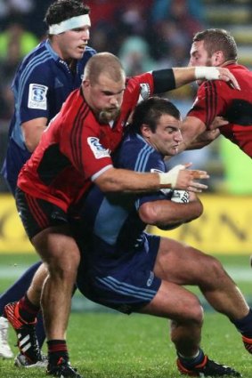 Over the top: Crusaders front-rower Owen Franks pulls off a tackle.