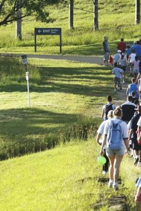 The crowd walks past the lake at the Campbelltown City Challenge Walk.