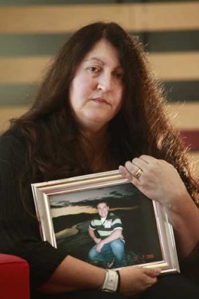 Sharon Fraser, with a picture of her husband Justin who died in Frankston Hospital, one of three deaths in the psychiatric ward.