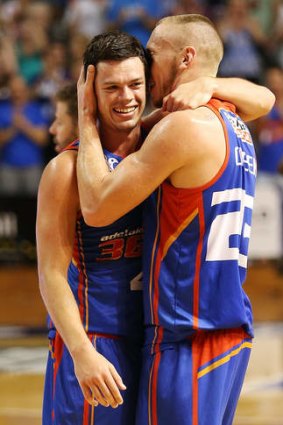 Finals drought over: Jason Cadee and Mitch Creek of the 36ers celebrate after the game three win over the Tigers.