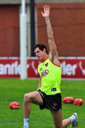 Jake Carlisle stretches during a training session at Windy Hill on Monday.