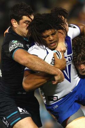 The Bulldogs jamal Idris cops the full force of the Panthers defence.
