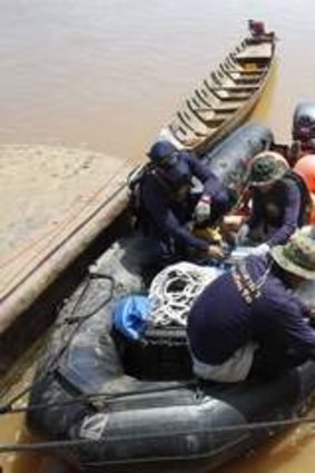 High-tech: Lao naval officials install sonar equipment on dinghies to search for the plane's black box.