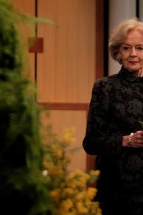 Governor-General Quentin Bryce contributes wattle and frangipani to a wreath yesteray.