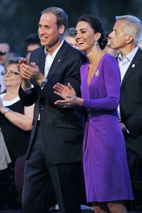 Duchess Catherine wears a purple V-neck dress by the British designer Issa.