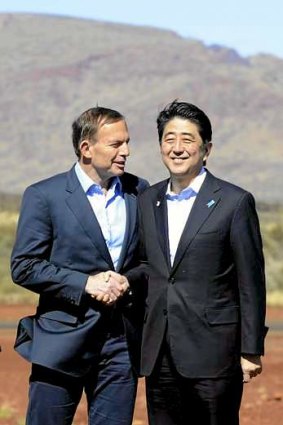 Australia's Prime Minister Tony Abbott and his Japanese counterpart Shinzo Abe arrive to tour the Rio Tinto West Angelas iron ore mine.