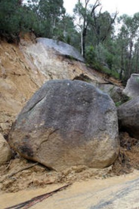 Large rocks block traffic on the road to Mount Buffalo yesterday.