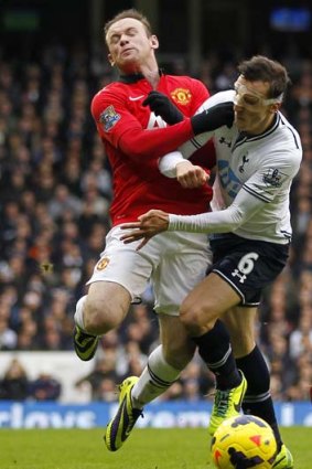 Tottenham Hotspur's Romanian defender Vlad Chiriches (R) fouls Manchester United's English striker Wayne Rooney at White Hart Lane.