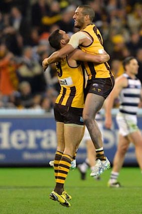 Victory dance: Shaun Burgoyne (left) and Josh Gibson celebrate the Hawks' fighting win over Geelong and a grand final berth.