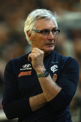 Mick Malthouse watches on from the boundary line.