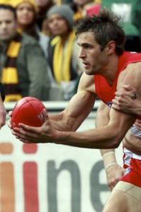 Josh Gibson attempts to tackle Josh Kennedy.