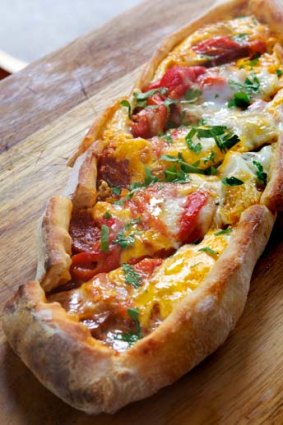 Pide with sucuk and green egg.