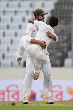 Jubliant: Bangladesh's Taijul Islam jumps on Shakib Al Hasan as they celebrate their historic Test win.