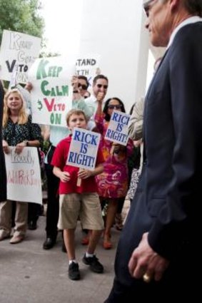 Texas Governor Rick Perry  leaves the Travis County courthouse. 