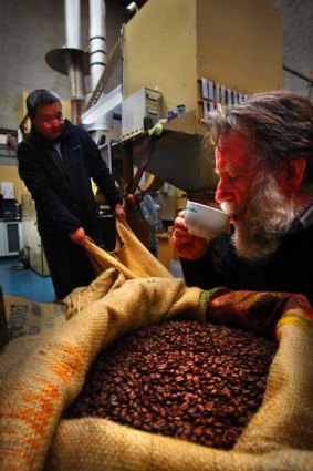Jaspers Caffeine Dealers owner Wells Trenfield samplesa brew as Tong Zhou prepares to roast a fresh batch of beans. <i>Picture: Craig Sillitoe</i>