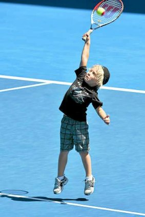 Cruz Hewitt takes to the court as his father, Lleyton, takes a break at training.
